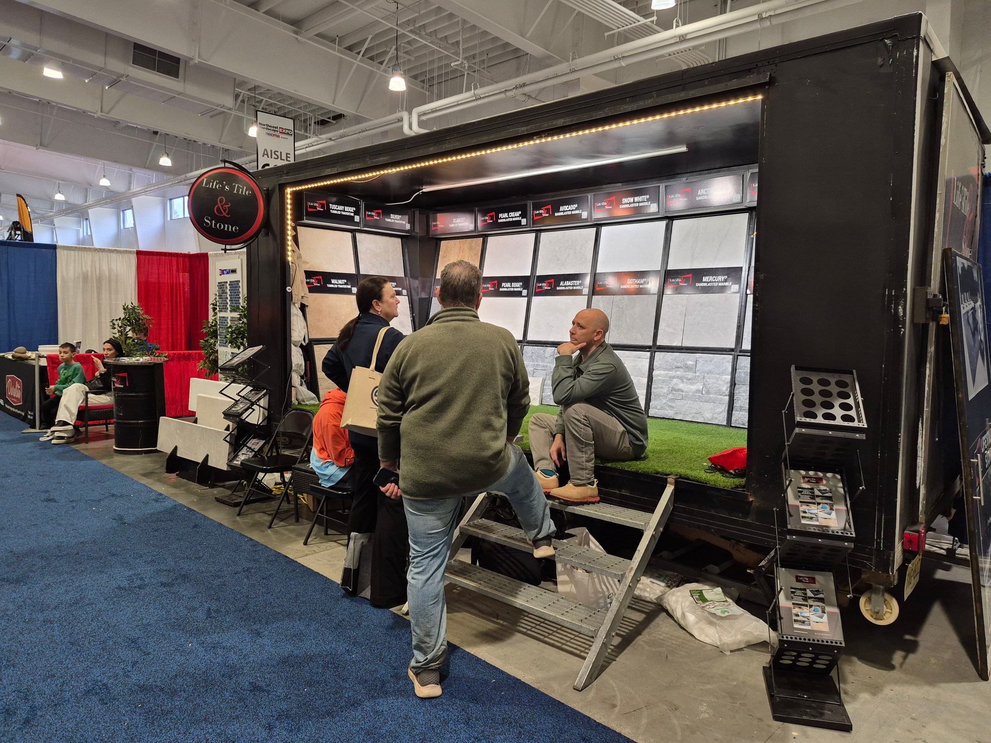 Visitors speaking with the Life's Tile & Stone team at the Northeast Hardscape Expo
