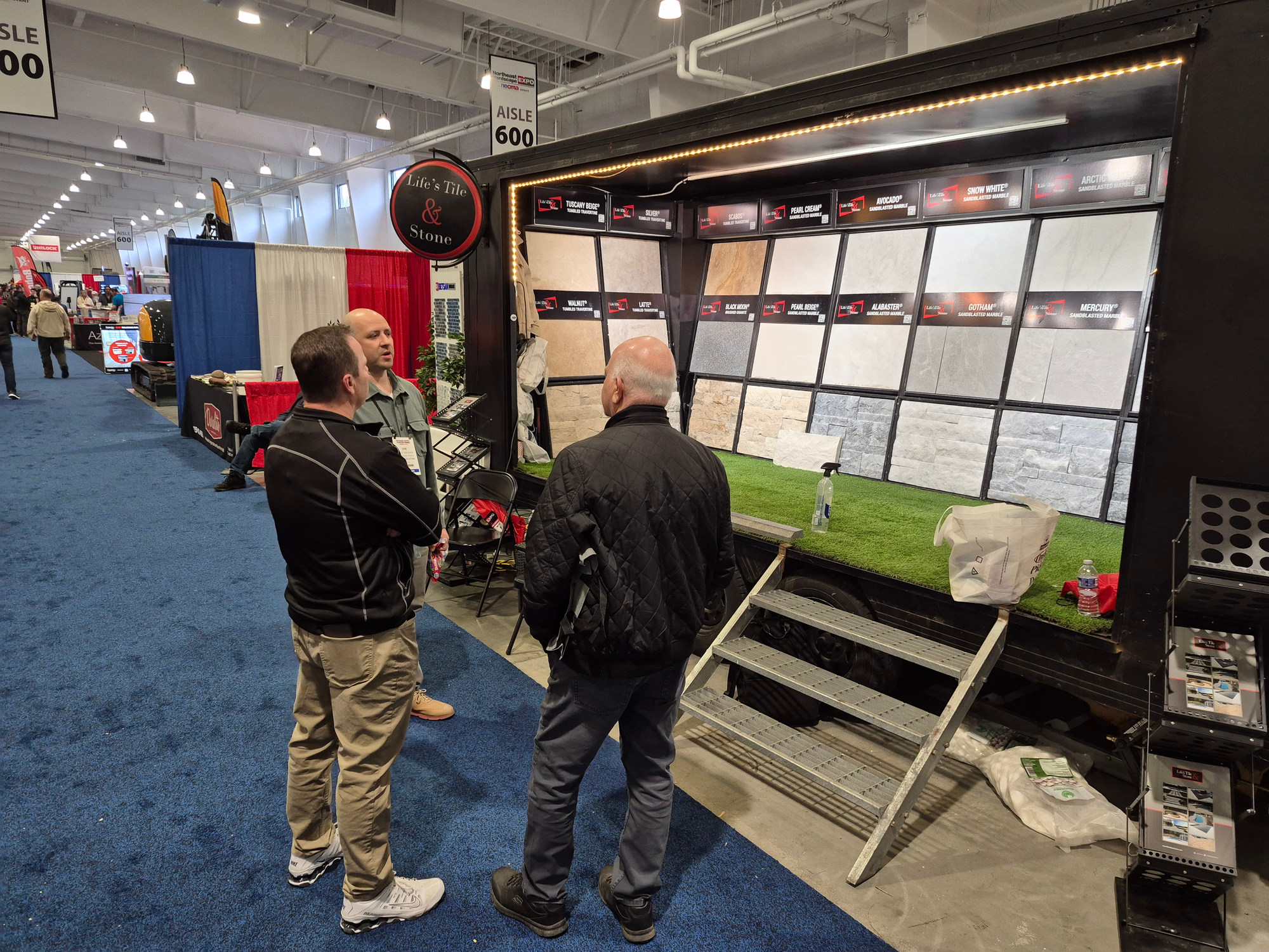 Visitors approaching the Life's Tile & Stone mobile showroom at the Northeast Hardscape Expo